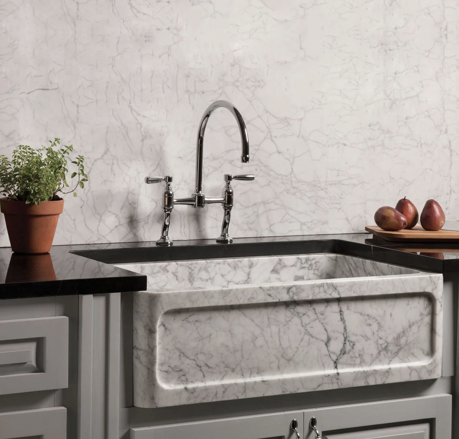 Marble farmhouse sink with chrome bridge faucet